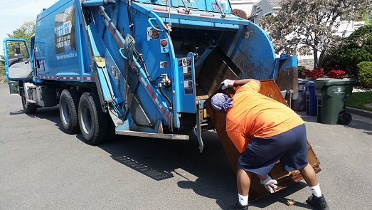 Refuse worker conducting a large item pick-up .