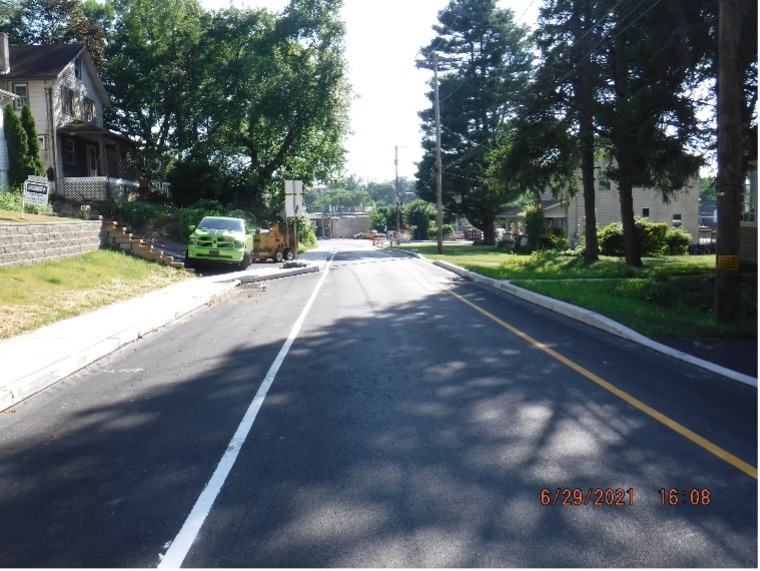 Final asphalt wearing course pavement with line striping on Edge Hill Road looking west between Tyson Ave. and Ardsley Ave.